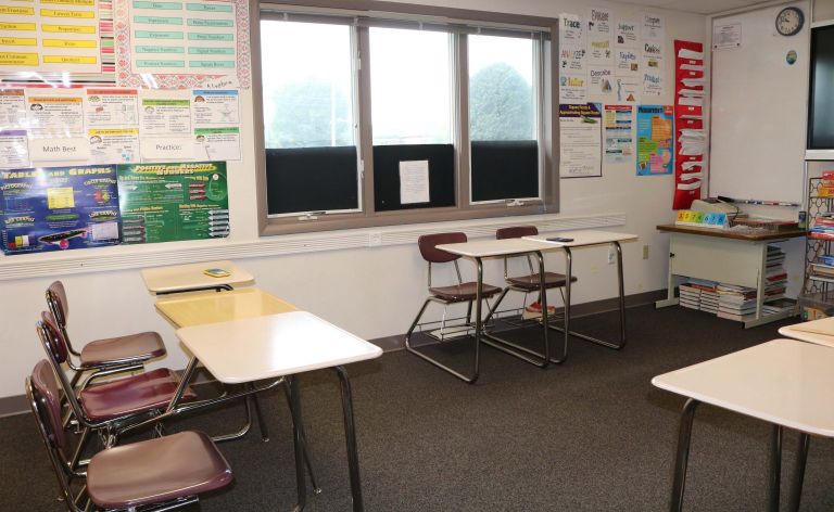 SLTC building interior room with 2 desks and chairs
